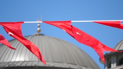 turkish flags waving near a mosque