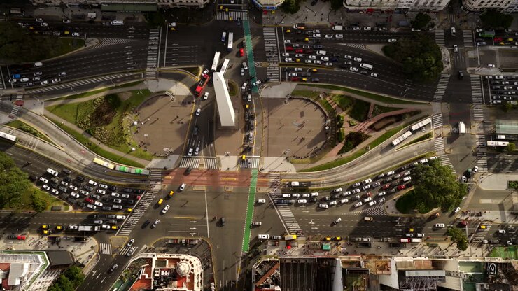 Top-down aerial view of traffic and the Obelisco monument at Avenida 9 de Julio in Buenos Aires
