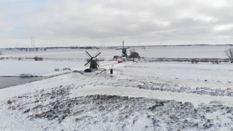 Traditional-Dutch-winter,-old-windmills-in-snowy-landscape,-aerial-view