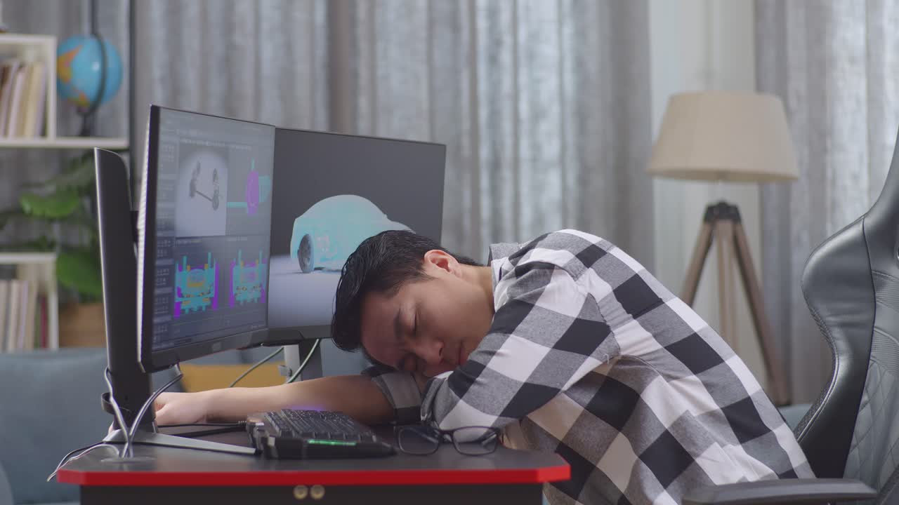 Tired Designer Taking a Nap at His Computer Desk