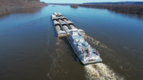 a towboat pushes barges north on the mississippi river