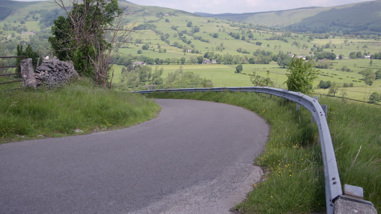 Winding Road Through a Green Valley Landscape