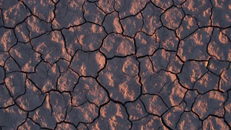 top down view of dry desert land, cracked soil patterns after drought