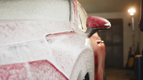 red suv being foamed for a car wash