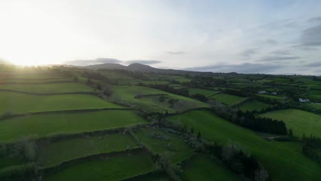 Golden-Horizon:-A-captivating-sunset-over-the-horizon-in-the-Azores,-with-lush-green-fields-in-the-foreground