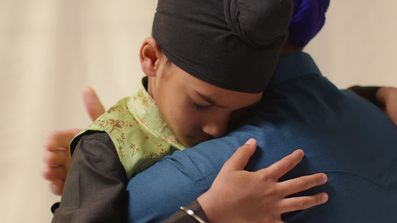 A father and son share a loving hug.