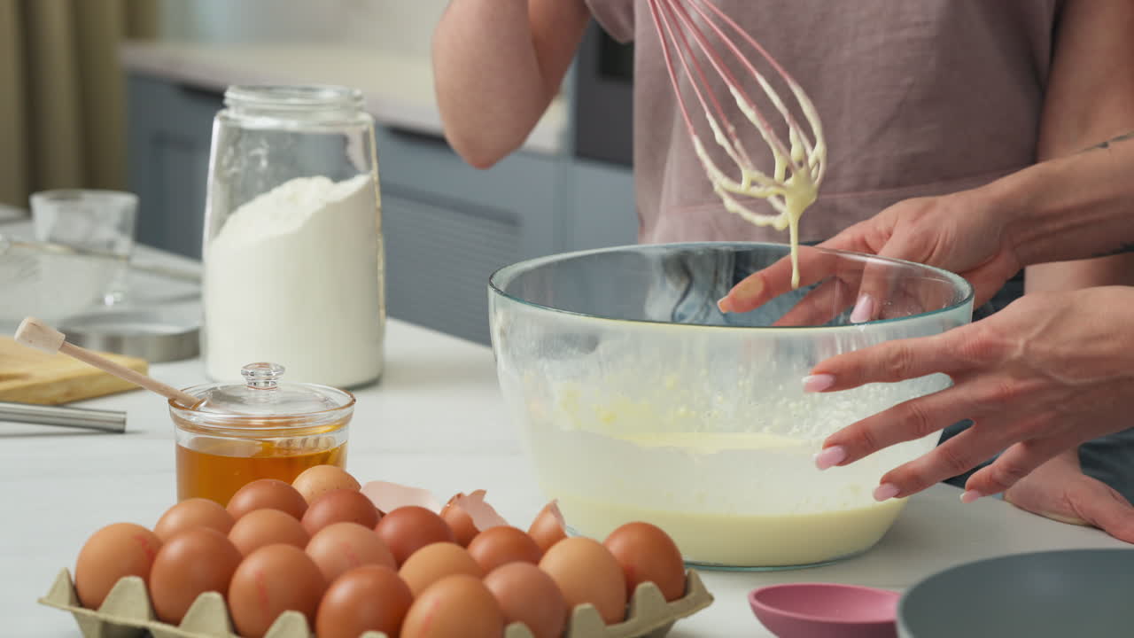 Close up of daughter stirring a creamy pancake batter