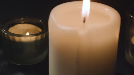 close up of model of hand used in palm reading surrounded by candles and crystals 2