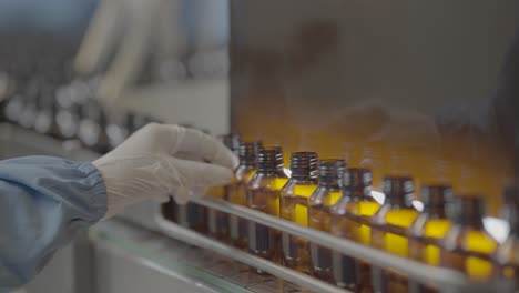 a person checking quality of syrup bottles slog footage.