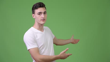 young handsome man presenting something