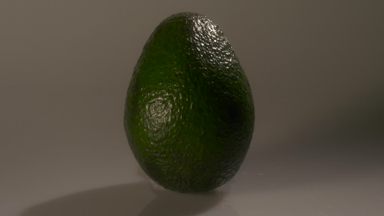 aguacate verde maduro sobre un fondo blanco
