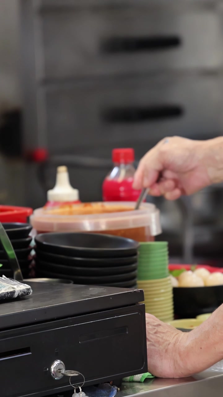 Close-up of Hand Stirring Sauce in a Commercial Kitchen