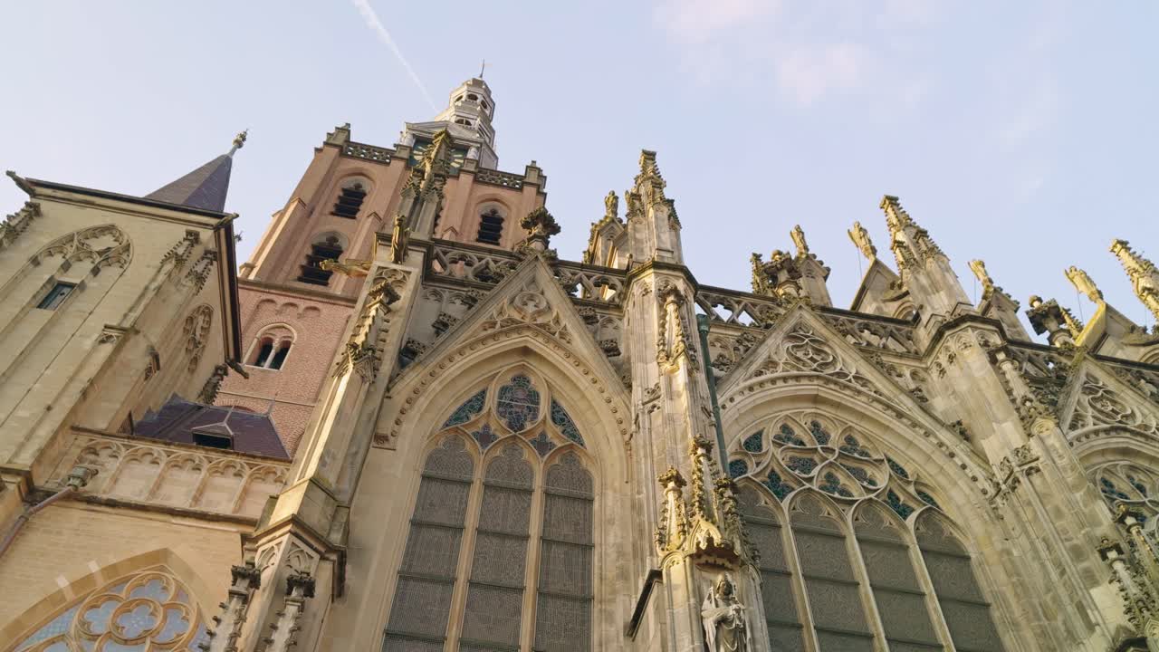 Saint John's Cathedral in 's- Hertogenbosch Den Bosch in Netherlands, low rotating angle view of the sky, building chapel and spires, authentic traditional Dutch European architecture style design