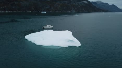 Aerial-of-a-motorboat-in-ice-water-by-a-giant-icecap