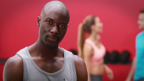 trainer smiling at the camera in crossfit gym