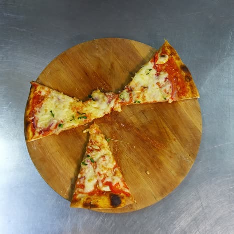 hands taking slices of pizza