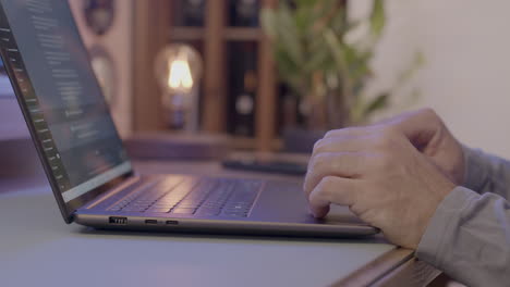 elderly man using chatgpt to generate text on a notebook in living room
