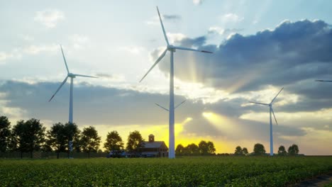 wind turbines standing in sunset. farm with wind turbines. generating clean renewable energy. bright orange sunset. alternative energy