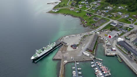 circling over the harbor of botnhamn with the ferry inside the port and long line of vehicles