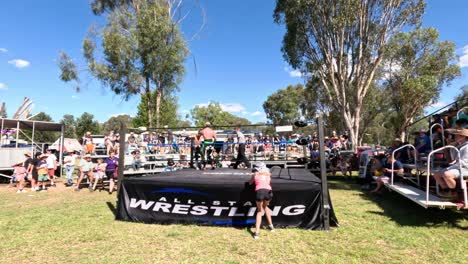 spectators watching a wrestling match outdoors