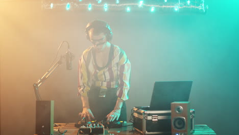 Female-DJ-playing-techno-music-at-stereo-mixer