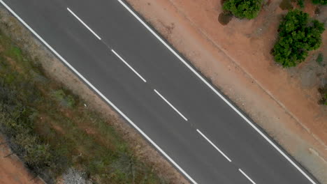 aerial view of a spinning road with a passing car