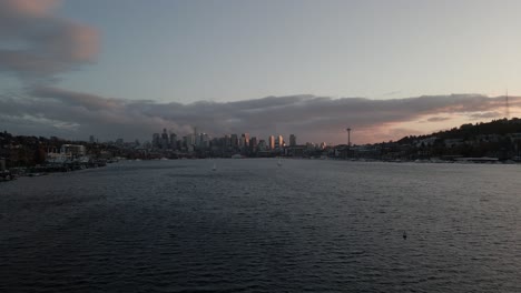 aerial shot over lake union revealing the seattle skyline at sunset