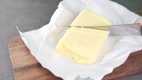 cutting butter on a wooden cutting board