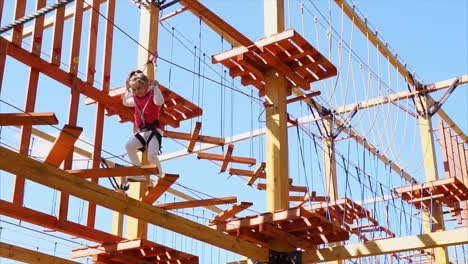 child climbing a ropes course