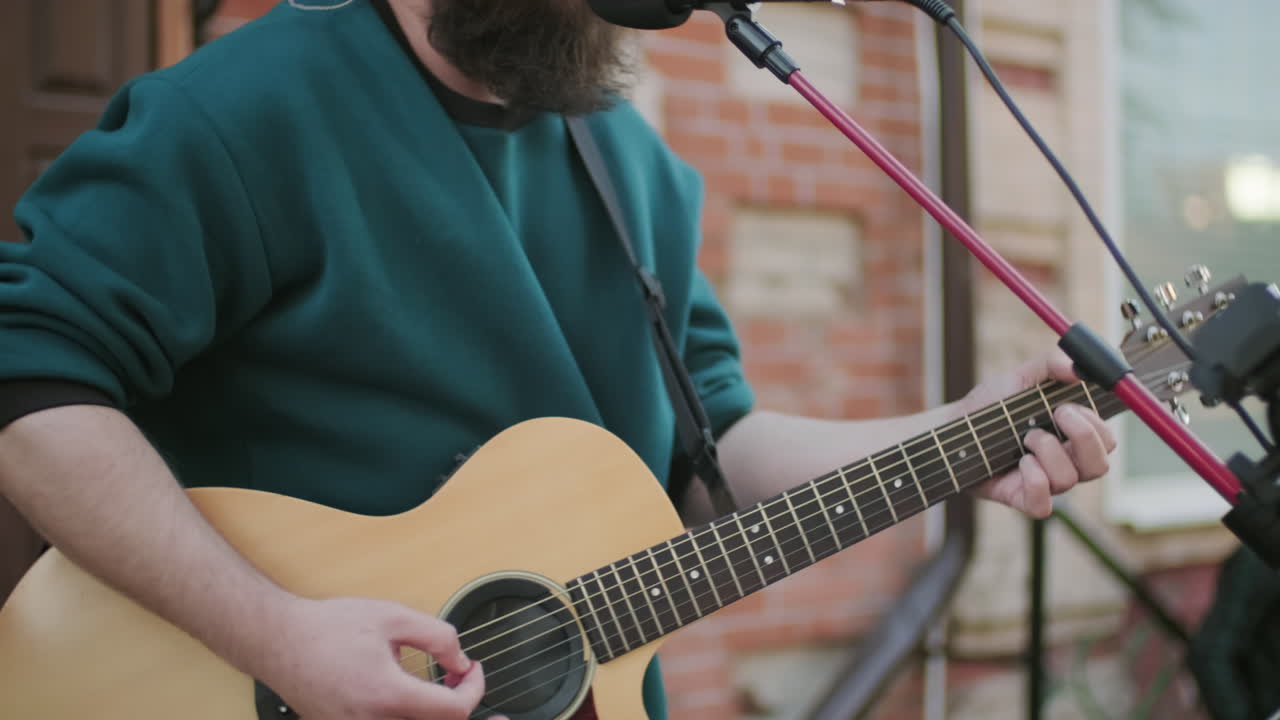 Man Singing Song and Playing Guitar on Street