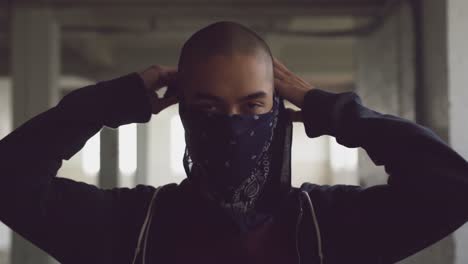 fashionable young man in an abandoned warehouse