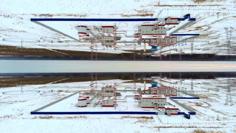 a drone flies over a gas turbine power plant in winter. varobatka of electricity from natural gas in northern countries with a harsh climate. the effect of reflection and two worlds. industrial