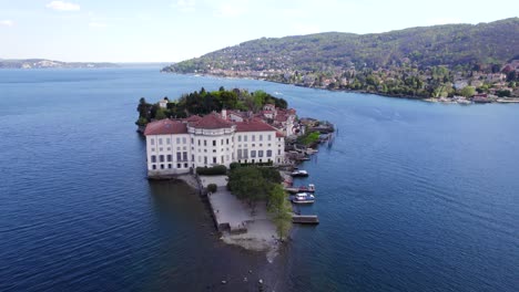 drone flying towards palace of isola bella in front of italian stresa village in lombardy