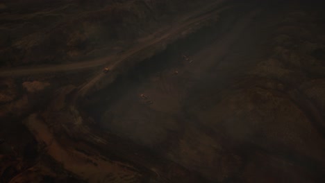 arial view of the opencast mine. front end loader loading sand into dump truck in open pit. heavy mining machinery working in quarry. truck transports minerals in opencast