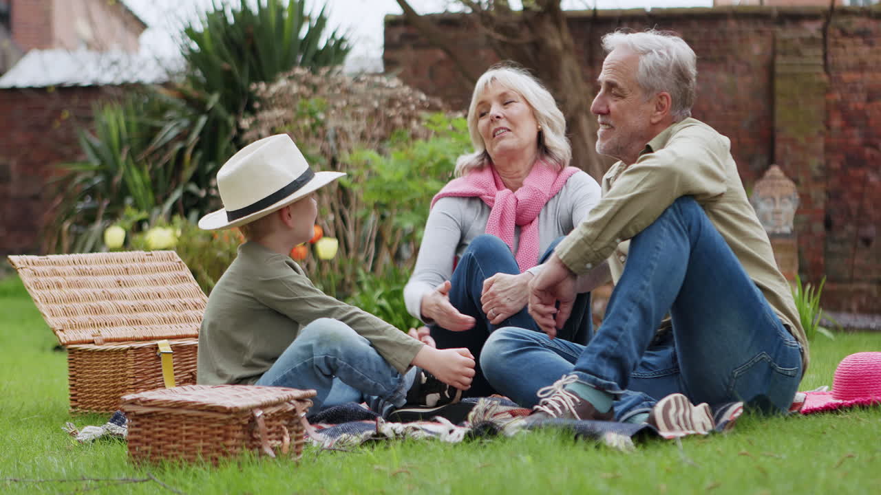 Family enjoys a picnic in the garden