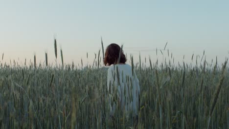 woman walking through a wheat field