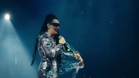 a female musician singing on stage at a concert