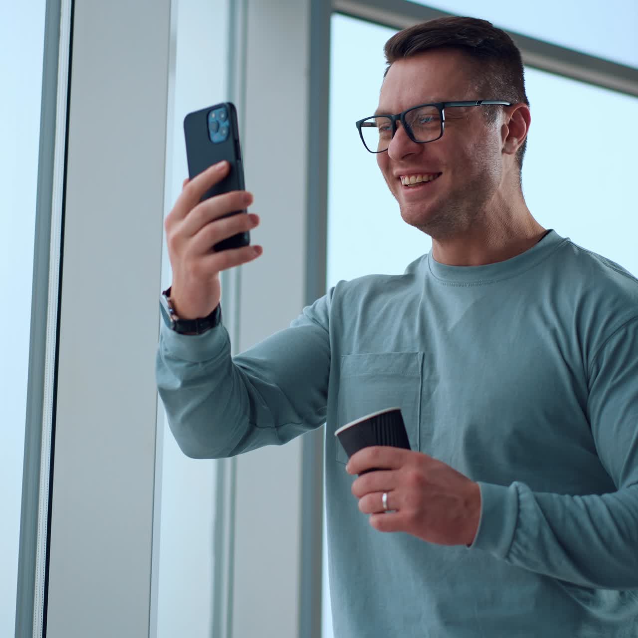 Successfull entrepreneur communicating with phone. Handsome young businessman have a phone call in office