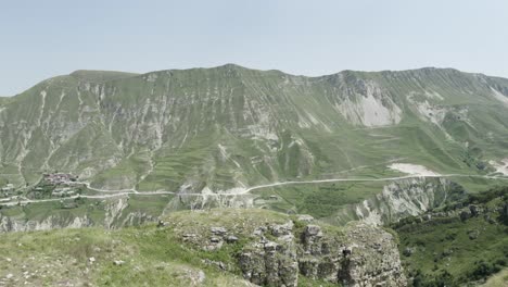 mountainous landscape with winding road and village