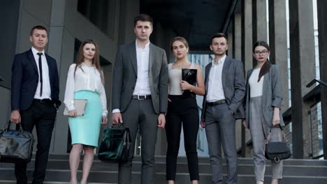 portrait of happy businesspeople men and women smiling looking at camera with joyful faces. people are wearing elegant formal clothing