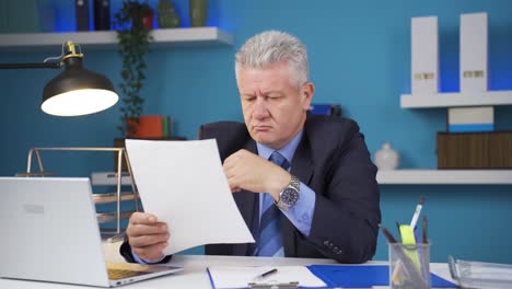 Businessman-thinks-looking-at-documents.