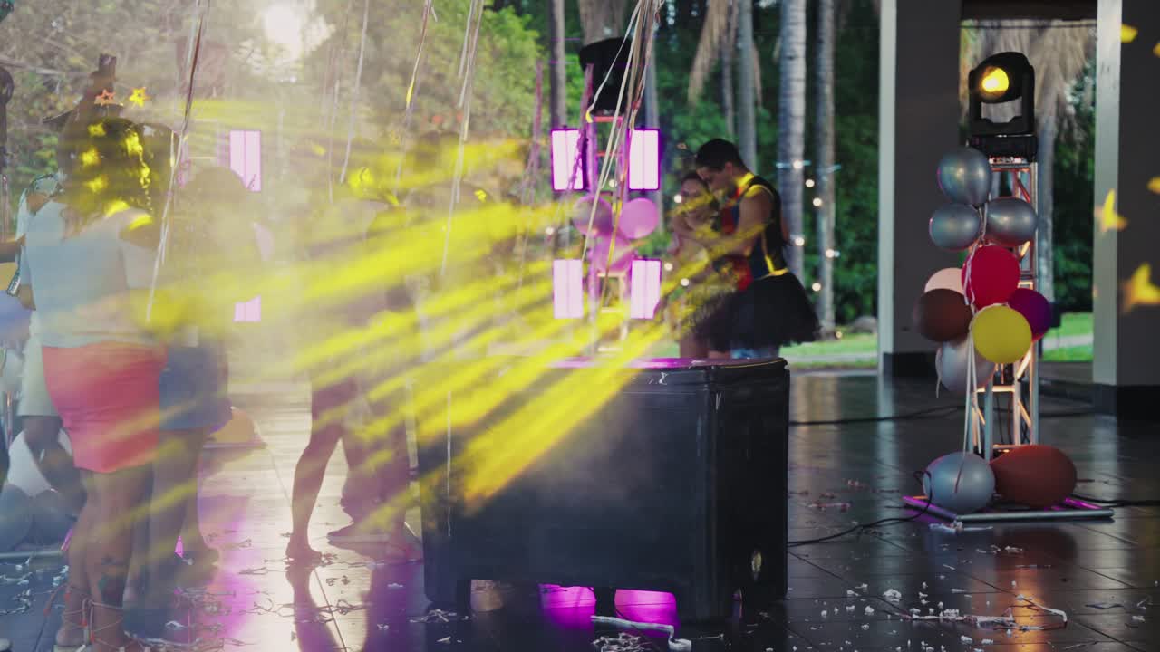 Diverse group dancing at a festive outdoor night party