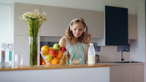 happy woman eating cornflakes breakfast in morning