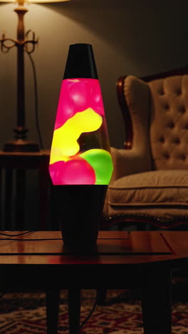 colorful lava lamp on a table in a dimly lit room