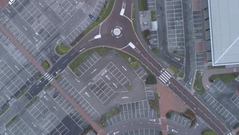 aerial view above empty quarantine corona virus outbreak shopping retail car park markings moving downwards