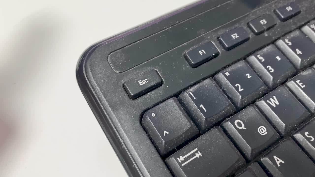 Pressing the escape button on an old dirty computer keyboard