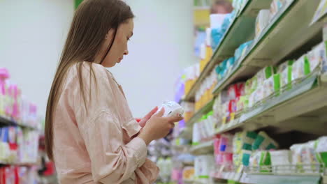 woman shopping for baby products in a supermarket