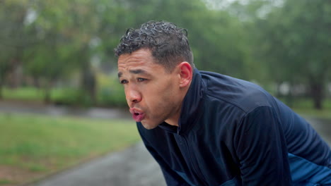 man exhausted after running in the rain