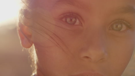 Portrait-of-mixed-race-girl-child-smiling-outdoors-at-sunset