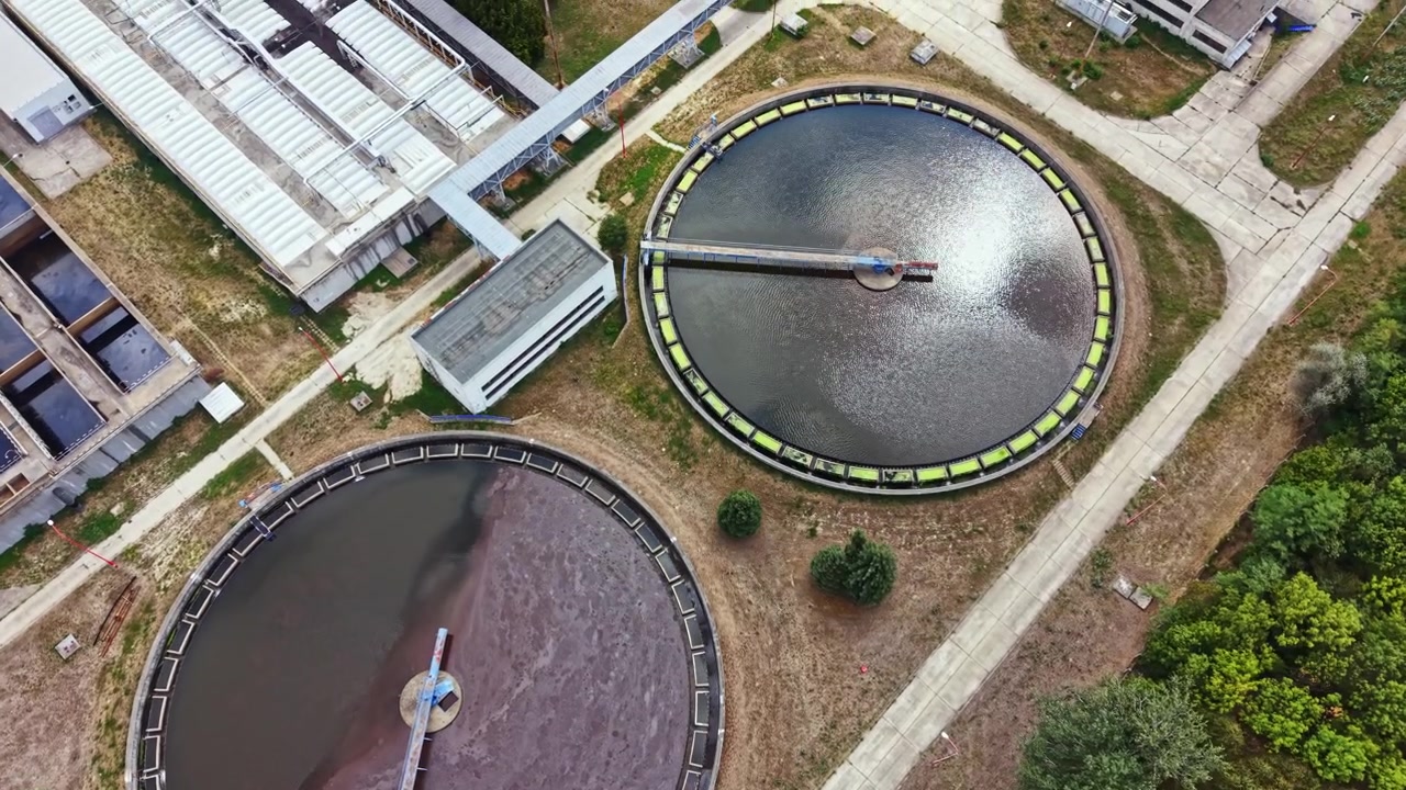 Water treatment facility shows large tanks for cleaning water in urban area during daylight hours